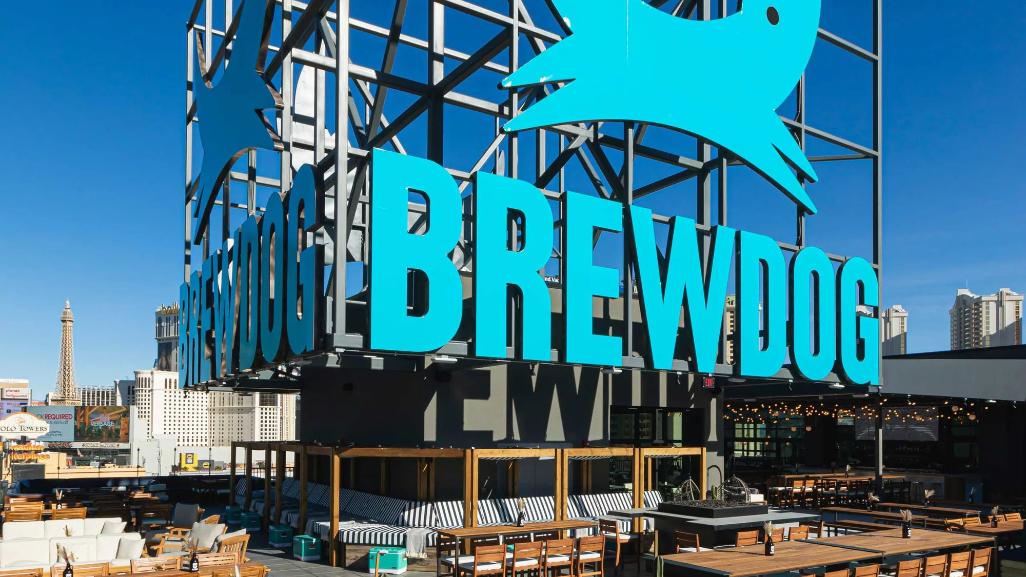 Exterior of a BrewDog bar showing the brand's black and yellow signage and beer taps